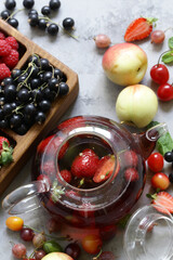 fruit tea in a teapot with fresh berries