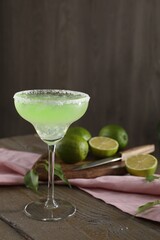Delicious Margarita cocktail in glass on wooden table