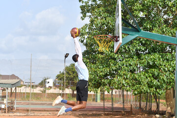 african basketball player making slam dunk © Vic Josh