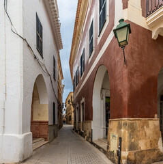 Charming and picturesque streets of Ciudadela. Cozy arcades formed by arches in various shades of color. Menorca, Spain