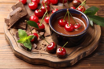 Fresh cherries with chocolate and mint on wooden table, closeup © New Africa