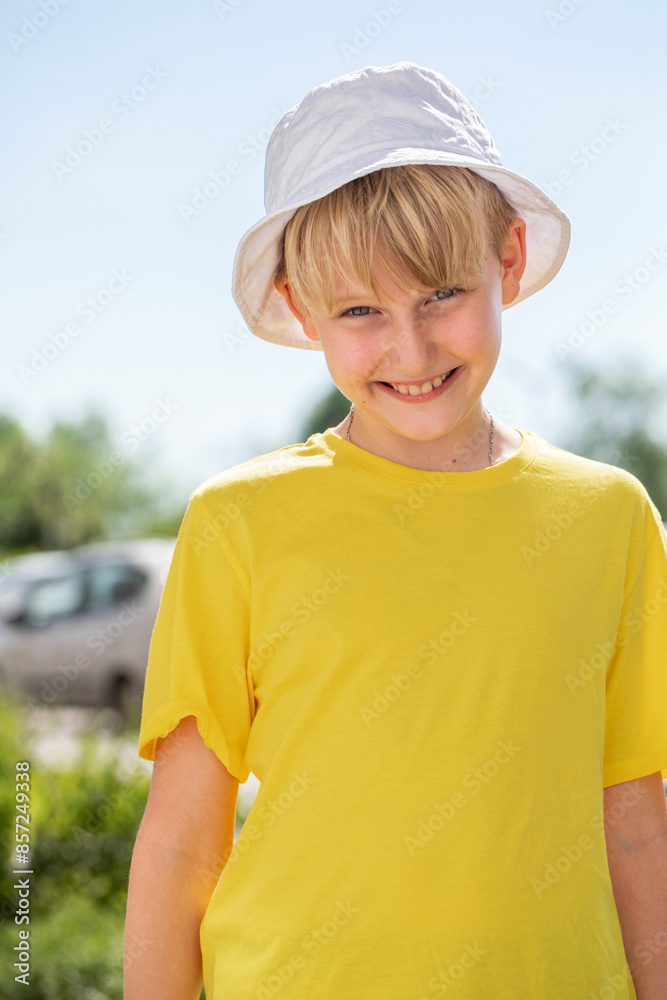 Wall mural Portrait of a little boy wearing a yellow t-shirt