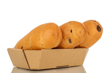 Three sweet buns with paper plate, macro, isolated on white background.