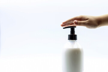 Hand hygiene concept. A child's hand on a soap bottle.