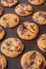 Homemade chocolate chip cookies on rustic background.