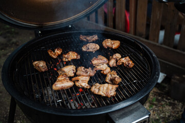 The tantalizing scent of the grilling chicken spreads through the air as it cooks with the lid open, creating a lovely atmosphere for outdoor cooking enthusiasts to enjoy