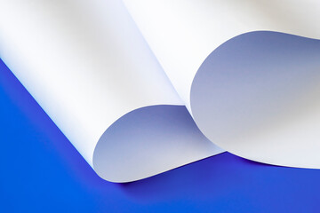Sheets of white paper on a blue background.