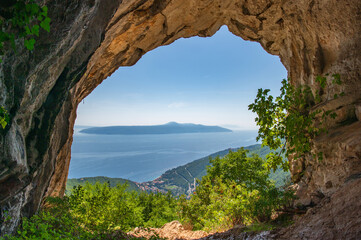 View of Adriatic Sea and island Cres, Croatia from the cave Pećina Druška peć on a sunny day. Mountain range Učka. Hiking concept © Lizaveta