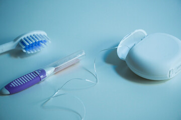 Dental floss next to an interdental brush and toothbrush, isolated on the white surface, oral...