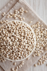 Organic White Beans in a Bowl, top view. Flat lay, overhead, from above.
