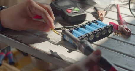 Add lead to melt and stick to the wires.Wires being soldered together with a soldering iron.Technician soldering two wires together on a pure.melting solder wire on soldering iron tip.