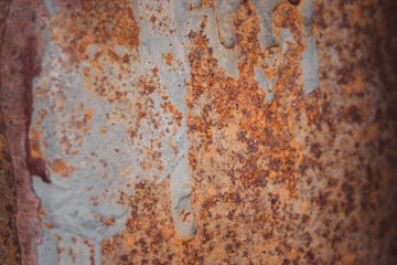 A rusty metal surface with a lot of paint and grime