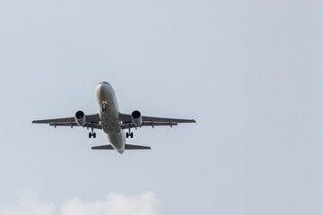 Airplane and sky, the plane is landing. Airplane take off on the blue sky, Aircraft flying on sky background. Passenger plane ready for landing. Low angle view of Airplane flying under blue sky