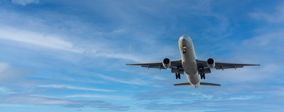Airplane and sky, the plane is landing. Airplane take off on the blue sky, Aircraft flying on sky background. Passenger plane ready for landing. Low angle view of Airplane flying under blue sky