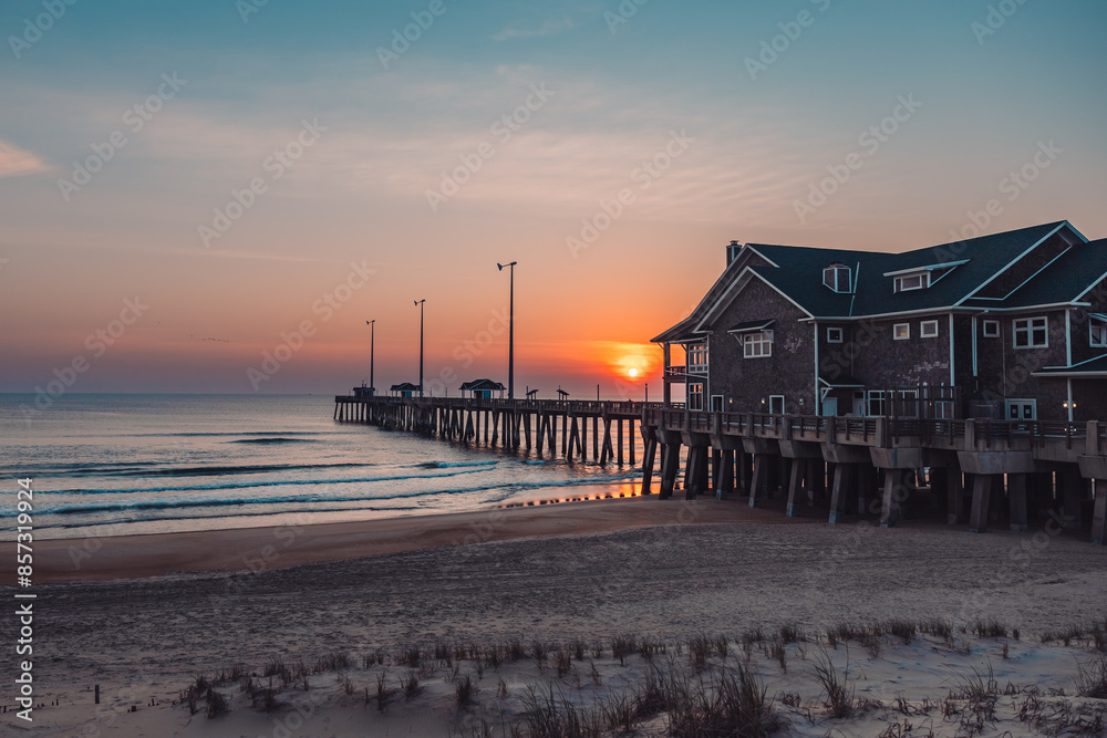 Wall mural sunrise or sunset on the pier by the ocean