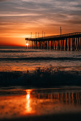 sunrise or sunset on the pier by the ocean
