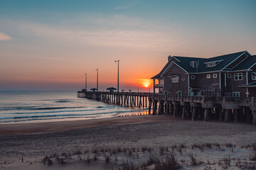 sunrise or sunset on the pier by the ocean