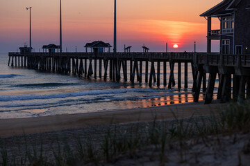 sunrise or sunset on the pier by the ocean