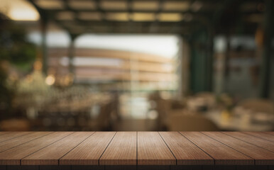 Empty wooden table top with lights bokeh on blur restaurant background.