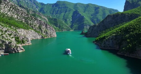 Ferry leaving Komani lake bay and heading towards the mountains in northern Albania
