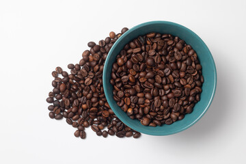 Green breakfast bowl full of coffee beans 