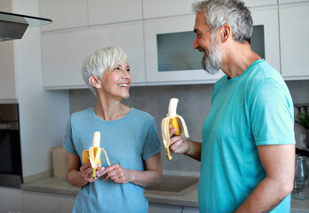 kitchen food woman healthy couple senior mature active fitness diet home eating adult lifestyle...