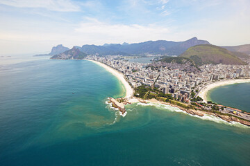 Aerial view, ocean and buildings in city, mountain and architecture in Brazil, tourism and destination. Morning, above and travel in Rio De Janeiro, water and outdoor for vacation and explore