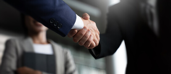 Businessman handshake for teamwork of business merger and acquisition,successful negotiate,hand shake,2024,two businessman shake hand with partner to celebration partnership and business deal concept