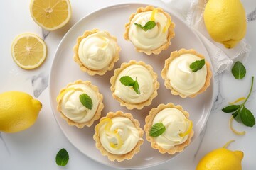 Mini lemon custard tarts arranged flatly with lemons