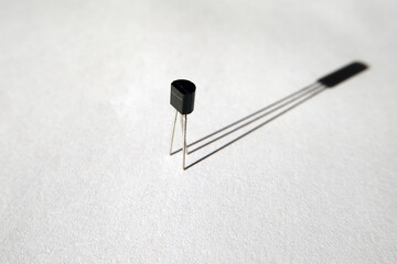 Single transistor and its shadow. Semiconductor electronic component.