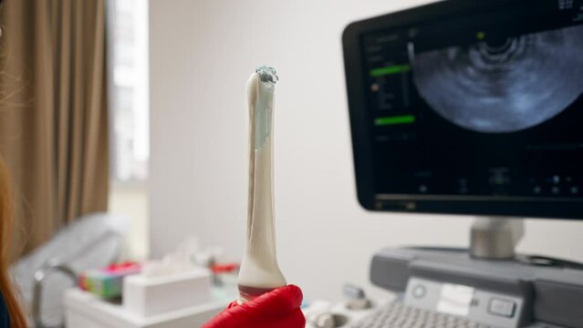 close-up in the clinic gynecological office the doctor holds the ultrasound machine ready