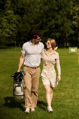 Fototapeta premium A sophisticated young couple in elegant attire walking on a luxurious golf course, enjoying a leisurely afternoon together.
