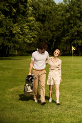 A stylish couple dressed in elegant attire leisurely walking across a manicured golf course.