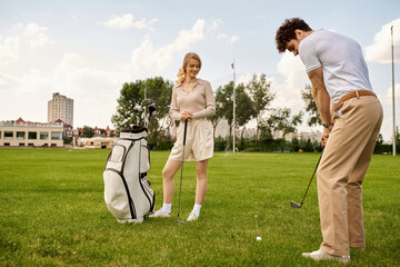 A man and woman dressed elegantly enjoy a round of golf on a lush green field, embodying an upscale lifestyle.