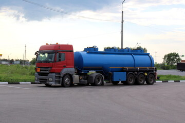 There is a Kamaz truck with a tank on the side of the road.