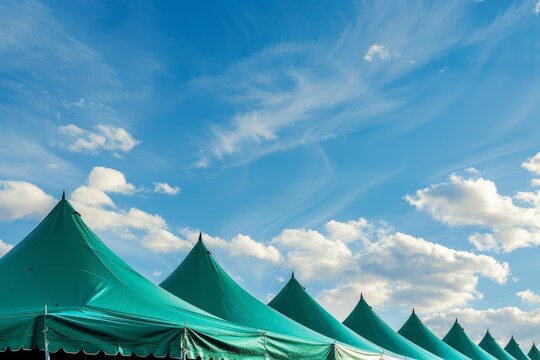Green event tents contrast with blue sky