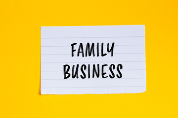 Family business message written on ripped white paper piece with yellow background. Conceptual family business symbol. Copy space.