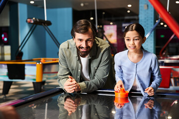 An exciting, fast-paced game of air hockey being played by father and child in a vibrant arcade setting.