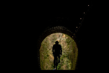 Cyclists riding through a tunnel