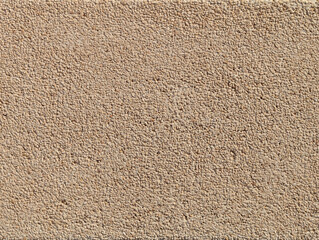 Light beige and cream gravel or washed stone and concrete block or tile for pool edging texture or background.