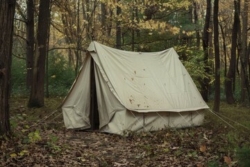 Old white canvas tent in forest