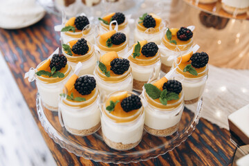 Wedding table, buffet, blackberry and lemon cheesecakes