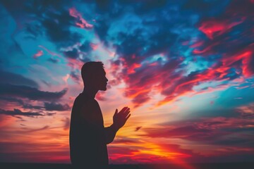 A person standing in front of a beautiful sunset, ideal for use as a symbol of hope or new beginnings