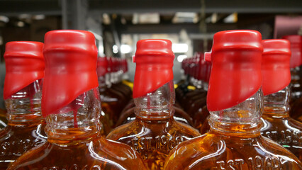 Close-up of many whiskey bottles with red sealing wax corks