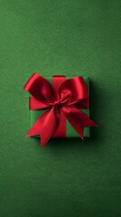 Green gift box with red ribbon on green background