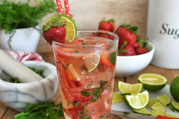Strawberry mojito cocktail drink with lime, white rum, moscato, strawberries and mint - cold refreshing summer beverage  