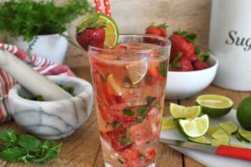 Strawberry mojito cocktail drink with lime, white rum, moscato, strawberries and mint - cold refreshing summer beverage  
