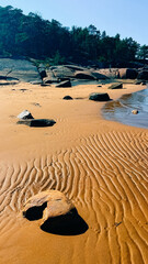 Ribbed sand and rocks on the shore of the White Sea