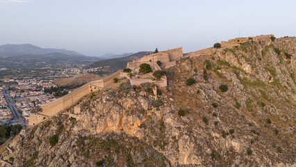 View from above on Nafplio city in Greece with port, Bourtzi fortress and blue Mediterranean sea soft focus