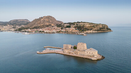 View from above on Nafplio city in Greece with port, Bourtzi fortress and blue Mediterranean sea soft focus